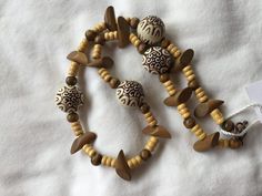 This handcrafted necklace was created using large round beige and black tribal pattern wood beads, beige tube wood beads, round brown wood beads and slanted brown tube wood beads. Wood Bead Necklace, Wire Necklace, Beige And Black, Handcrafted Necklace, Beads And Wire, Tube Beads, Brown Wood, Bead Necklace, Wood Beads