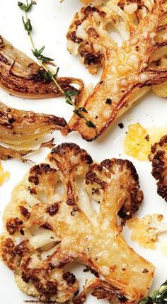 roasted cauliflower on a white plate with herbs