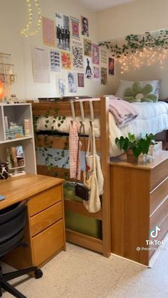 a bedroom with a bed, desk and shelves filled with clothes on it's sides