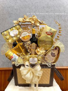 a gold gift basket with champagne and chocolates