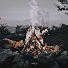 there is a fire in the middle of some rocks