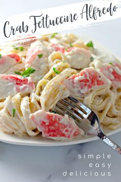 a close up of a plate of food with pasta and lobster on it, text overlay reads crab fettuccine alfredo