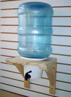 a large blue water bottle sitting on top of a wooden shelf