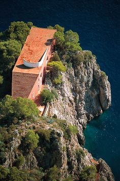 an aerial view of a house on top of a cliff