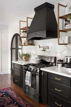 a black stove top oven sitting inside of a kitchen