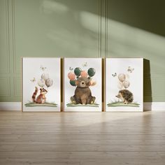 three framed pictures with animals and balloons on them in front of a green painted wall