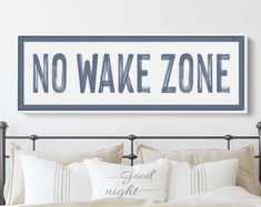 there is a bed with pillows on it and a sign that says no wake zone