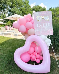 an inflatable heart shaped balloon with a welcome sign