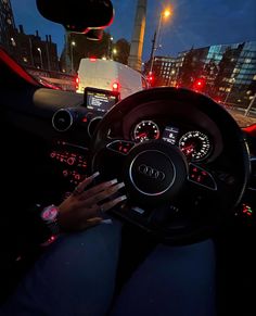 the interior of a car is lit up at night with red and white lights on