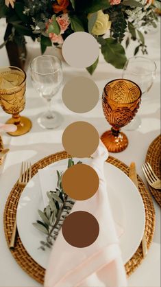 the table is set with plates, napkins and place settings for an elegant dinner