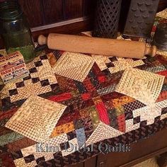 a quilted table top with a rolling pin on it