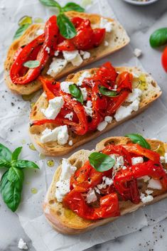 three slices of bread topped with tomatoes and cheese