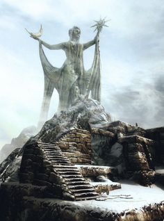 a statue is standing on top of a mountain in the snow with stairs leading up to it