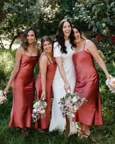 bridesmaids in red dresses posing for the camera