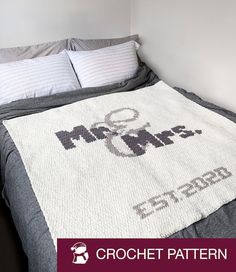 a crochet blanket on top of a bed