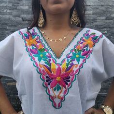 Beautiful colorful Hand Embroidered Mexican Flower Shirt made in Chiapas, Mexico. Cotton Shirt can be machine washed in cold water, hang to dry and warm iron. Each shirt is hand embroidered and flower will vary but each one is beautiful and unique Any questions please feel free to contact me DOES NOT INCLUDE THE BELT Traditional V-neck Top With Chikankari Embroidery, Multicolor Embroidered Cotton V-neck Top, Beach Cotton Embroidered Shirt, Floral Embroidered Cotton Beach Shirt, Cotton Floral Embroidery Beach Shirt, Cotton Beach Shirt With Floral Embroidery, Beach Cotton Shirt With Floral Embroidery, Floral Embroidered Cotton Shirt For Beach, Embroidered Cotton V-neck Shirt