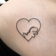 a heart shaped tattoo with a dinosaur holding a baby in it's back pocket