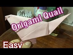 an origami paper airplane sitting on top of a table with the words easy