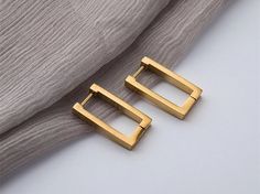 ♥ ∙E A R R I N G S♥ * Material: High Quality Titanium Steel * Finish: Titanium Steel 14K Gold Pated  * Featuring: Water-Resistant, Anti Tarnish, Hypoallergenic This trendy Rectangle earrings are made of titanium steel with a thick 14k gold platted It is designed for your daily wear look Minimalist and Beautiful The simple yet timeless design makes it a good addition to your jewelry collection.14K gold plated brass *instructions on how to take care plated Earrings. *Avoid water and chemicals: Avo Luxury Elegant Square Hoop Earrings, Cheap Hypoallergenic Rectangular Earrings, Rectangular Earrings, Punk Earrings, Titanium Earrings, Luxury Earrings, Party Earrings, Square Stud, Trendy Earrings