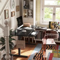 a home office with desk, chair and bookshelf next to stairs leading up to the second floor