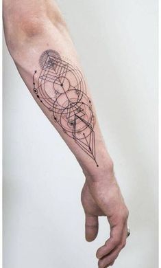 a person with a tattoo on their arm is pointing to the left side of his arm