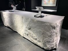 a table that has some kind of rock on it in the middle of a room