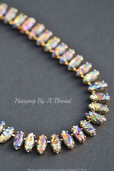 "A stunning new necklace made using incredibly rare vintage black fire opals. I was so lucky to get my hands on a few super colorful black opals in marquise shape. They are vintage stock from the 1950s. They are mand made glass opals, made in Western Germany. The opals have a black base with flecks of gold, oranges, blues, and greens. They have a blue \"haze\" to them (some more than others) and a bluish tint that seems to glow when the stone is turned.  Each opal is hand set into gold pronged chain. Stones are 15mm tall (5/8\") and are all hand set. Rhinestone portion is 12\" long  while the remainder of length is made up with gold plated rolo chain. Please choose desired necklace length at checkout. VERY limited stock rhinestones and chain.  * Nickel and lead free" Dainty Opal Necklace, Opal Necklace Gold, Black Fire Opal, Black Opal Pendant, Australian Opal Pendant, Tourmalated Quartz, Fire Opals, Western Necklaces, Antique Silver Jewelry