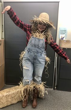 a scarecrow dressed in overalls and straw