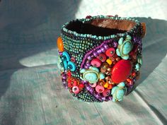 Beautiful hand beaded cuff bracelet made with an assortment of seed and other novelty beads and backed with Ultrasuede . Fits a 7"wrist with snap closures. Can be custom made to order. Unique Colorful Beaded Cuff Bracelet For Festivals, Unique Festival Cuff Bracelet With Colorful Beads, Beaded Cuff Bracelet For Festivals, Brown Beaded Bohemian Cuff Bracelet, Bohemian Beaded Cuff Bracelets As Gift, Festival Beaded Cuff Bracelet, Unique Beaded Cuff Bracelets As Gift, Unique Cuff Beaded Bracelets For Gifts, Unique Cuff Bracelet With Round Beads For Festivals