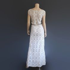 "This 70s-era column dress is meticulously hand-crocheted in a fine white wool with silver metallic accents. Makes a great springy statement dress or alternative wedding down. Dress is unlined and zips up back. Much better quality than modern versions of this dress. Best fits size medium or large (please refer to measurements below for best fit). Approximate Flat Measurements: Multiply times 2 for bust, waist, and hip measurements. For best fit, compare with a similar style of clothing which you White Fitted Crochet Maxi Dress, Elegant Floor-length Crochet Dress, Fitted Crochet Wedding Dress With Scalloped Lace, Elegant Crochet Maxi Dress For Wedding, Elegant Maxi Length Crochet Dress For Wedding, Elegant Maxi Length Crochet Wedding Dress, Fitted White Crochet Dress For Wedding, Crochet Lace Maxi Dress For Wedding, White Elegant Maxi Dress With Crochet Lace