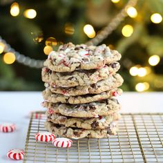 a stack of cookies sitting on top of a cooling rack next to candy canes