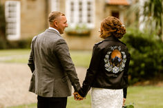 the bride and groom are holding hands