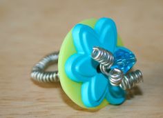 a blue flower ring sitting on top of a wooden table