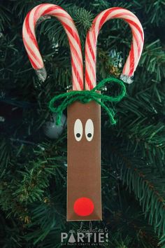 a christmas ornament with candy canes in it's mouth and nose