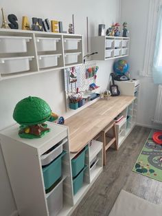 a child's playroom with toys and bookshelves on the wall next to it