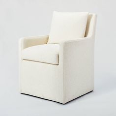 a white chair sitting on top of a white floor