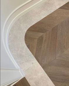 the corner of a bathroom with wood flooring