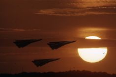 the sun is setting behind three fighter jets