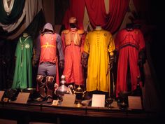 an assortment of costumes on display at a museum