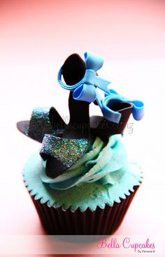 a cupcake with blue frosting and decorations on top