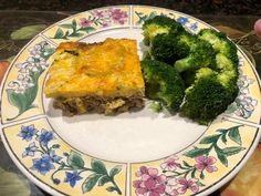 a white plate topped with broccoli and a piece of meat casserole