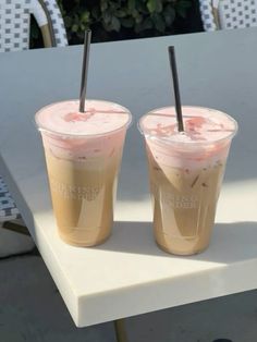 two drinks sitting on top of a white table