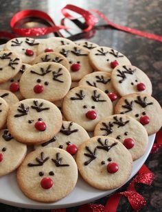 a plate full of cookies with reindeer faces on them