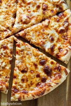 a sliced pizza sitting on top of a wooden cutting board