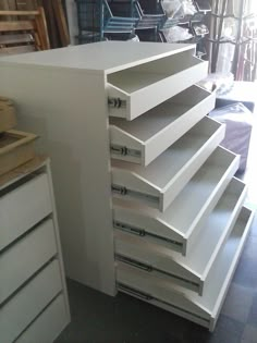 a large white cabinet with drawers in a room