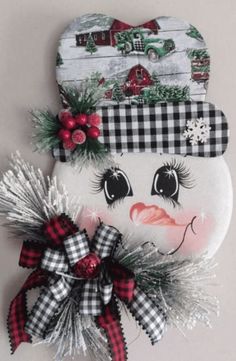 a snowman decoration hanging on the side of a wall