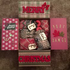 a box filled with lots of different types of christmas decorations on top of a carpet