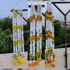 an arrangement of flowers hanging from a metal structure