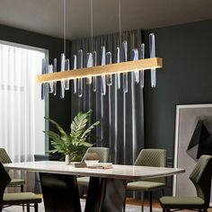 a dining room table with chairs and a large light fixture hanging from the ceiling over it