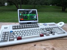 a laptop computer sitting on top of a keyboard